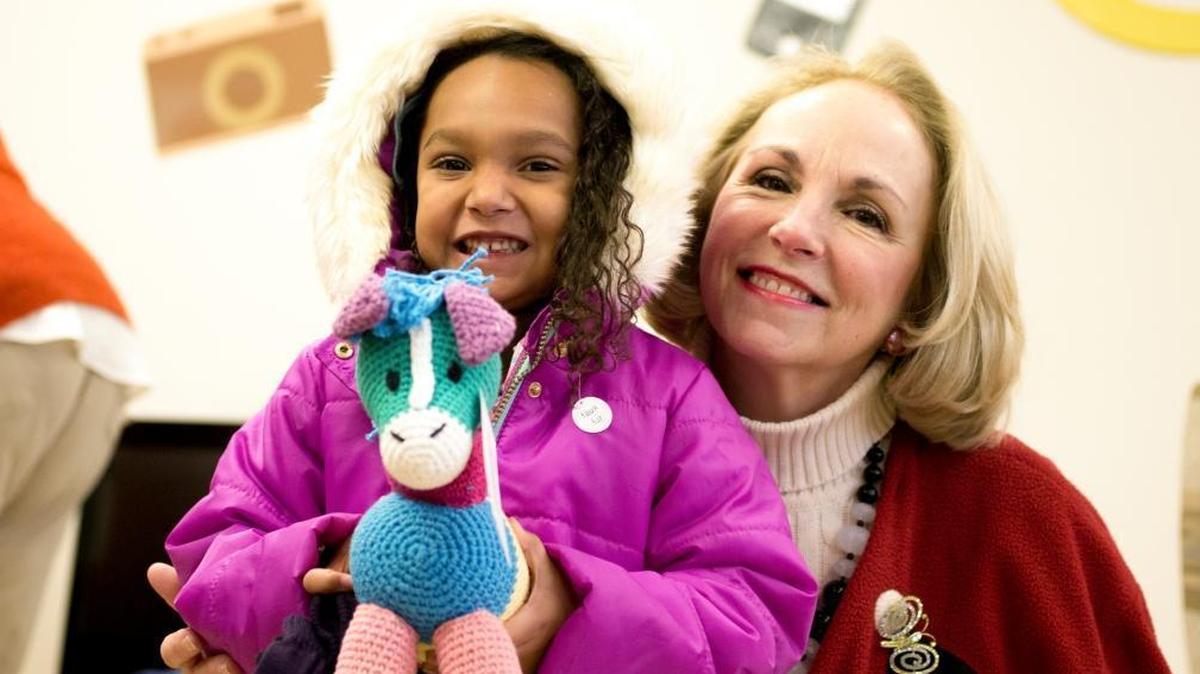 Nancy Ronquillo, president and chief executive officer of Children’s Home and Aid, and one of the thousands of children who received warm clothing and gifts at the agency’s gift drives.
