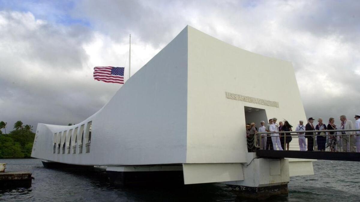 
Military and civilians file into the USS Arizona Memorial at Pearl Harbor on Tuesday, December 7, 2004, in Pearl Harbor, Hawaii. More than 2,000 sailors lost their lives in the attack, along with several hundred other servicemembers and civilians.
