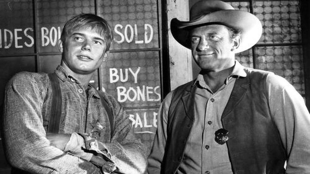 
Roger Ewing with James Arness on “Gunsmoke.” Ewing played deputy marshal and handyman Clayton Thaddeus “Thad” Greenwood in 36 episodes from 1965 to 1967. 
