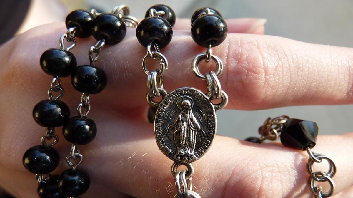 A close-up of a rosary, often used as a guide for Christians, especially Catholics, during prayer.