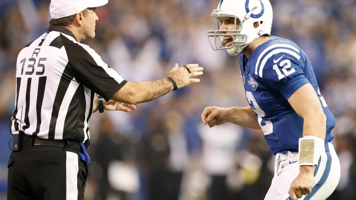 Indianapolis Colts quarterback Andrew Luck talks with referee Pete Morelli after the Colts first touchdown in a 2013 game in Indianapolis.