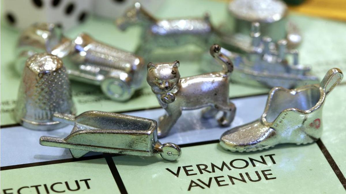 In this Feb. 5, 2013 file photo, the thimble game piece, left, sits among other Monopoly tokens at Hasbro Inc., headquarters in Pawtucket, R.I. The thimble will no longer be a game piece in Monopoly, rejected in 2017 in a campaign to determine the tokens for the next generation of the game.