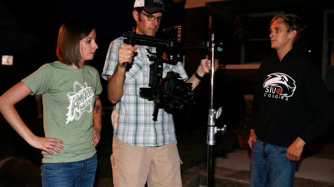 SIUE instructor Cory Byers, center, and freelance videographer Ashley Seering, left, prepare to shoot a nighttime scene in Edwardsville with SIUE student Justin Grimmer.