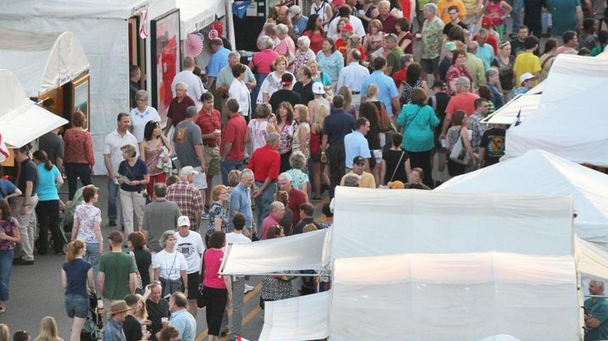 A crowd gathers around the booths on the West Main Street section of Art on the Square.