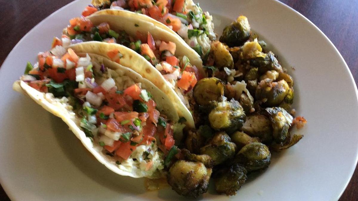 Cajun grilled tilapia tacos with crunchy Cajun slaw and fresh pico de gallo are served with fried Brussels sprouts at J&T’s Caliber restaurant in Sparta.