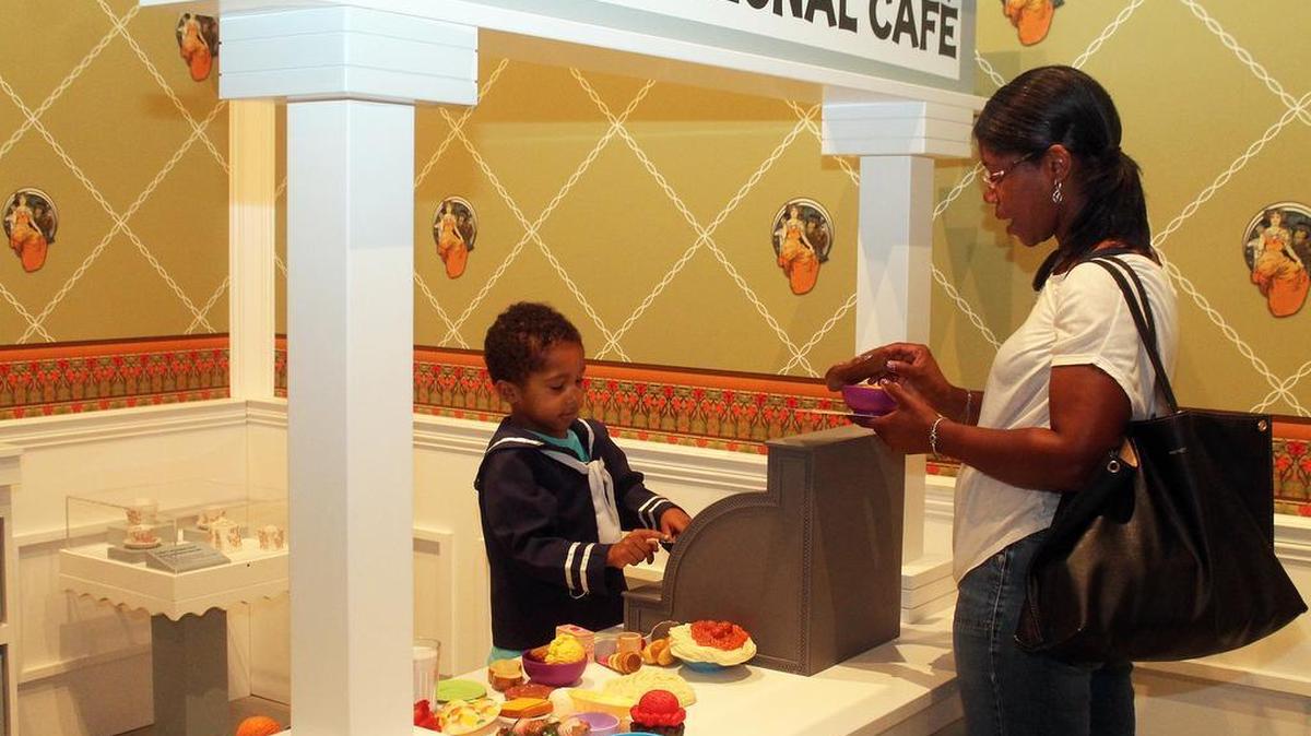 
Santana Martinez, 5, of Belleville, sells macaroni and cheese and bread to his mom in the Forest Park section of History Clubhouse, an area for children at Missouri History Museum.
