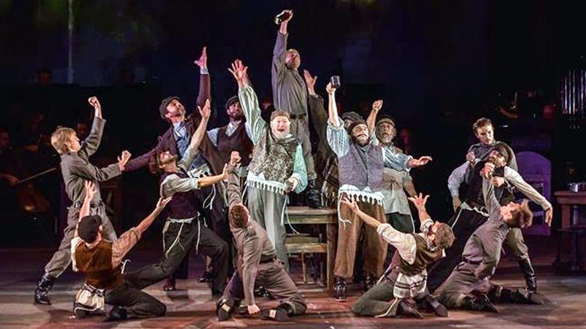 The cast performs “To Life” in The Muny’s production of “Fiddler On The Roof” through Friday night.