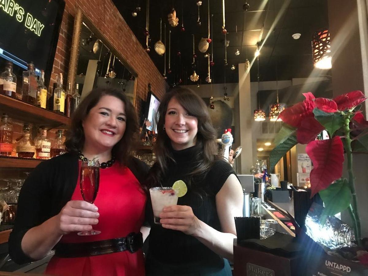 Stephanie Gain and Amanda Schlecht, the owners of Seven Belleville, pose for a photo with their Christmas Cocktails.