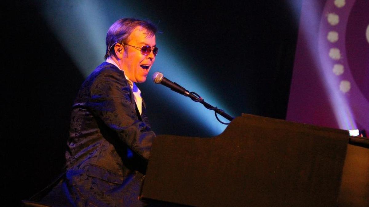 John Gore sings and plays the piano with the Dogs of Society, the Ultimate Elton Rock Tribute.