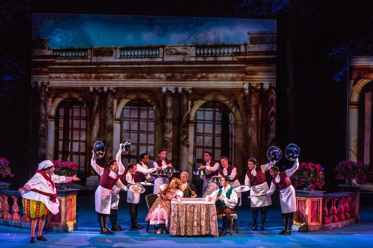 Ariel and Prince Eric (Emma Degerstedt and Jason Gotay) dine in the caste, with Chef Louis (Frank Vlastnik) singing “Les Poissons.”