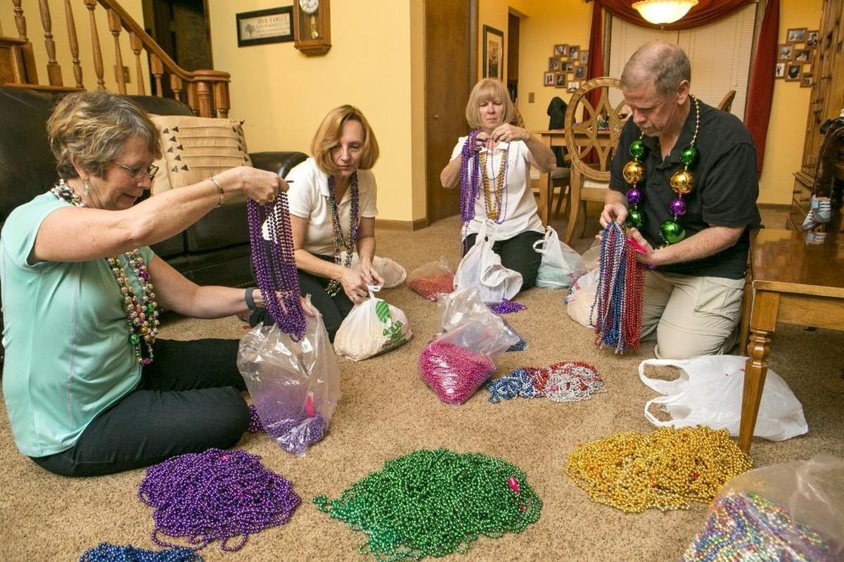 Gateway Milers Walking Club members sort beads for last year’s Mardi Gras Madness fun walk.