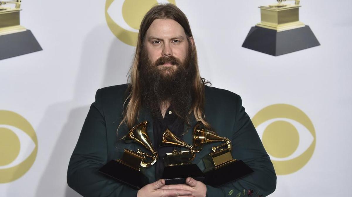 Chris Stapleton poses in the press room with his awards for best country solo performance for “Either Way”, best country song for “Broken Halos” and best country album for “From a Room: Volume 1” at the 60th annual Grammy Awards at Madison Square Garden on Sunday, Jan. 28, 2018, in New York.