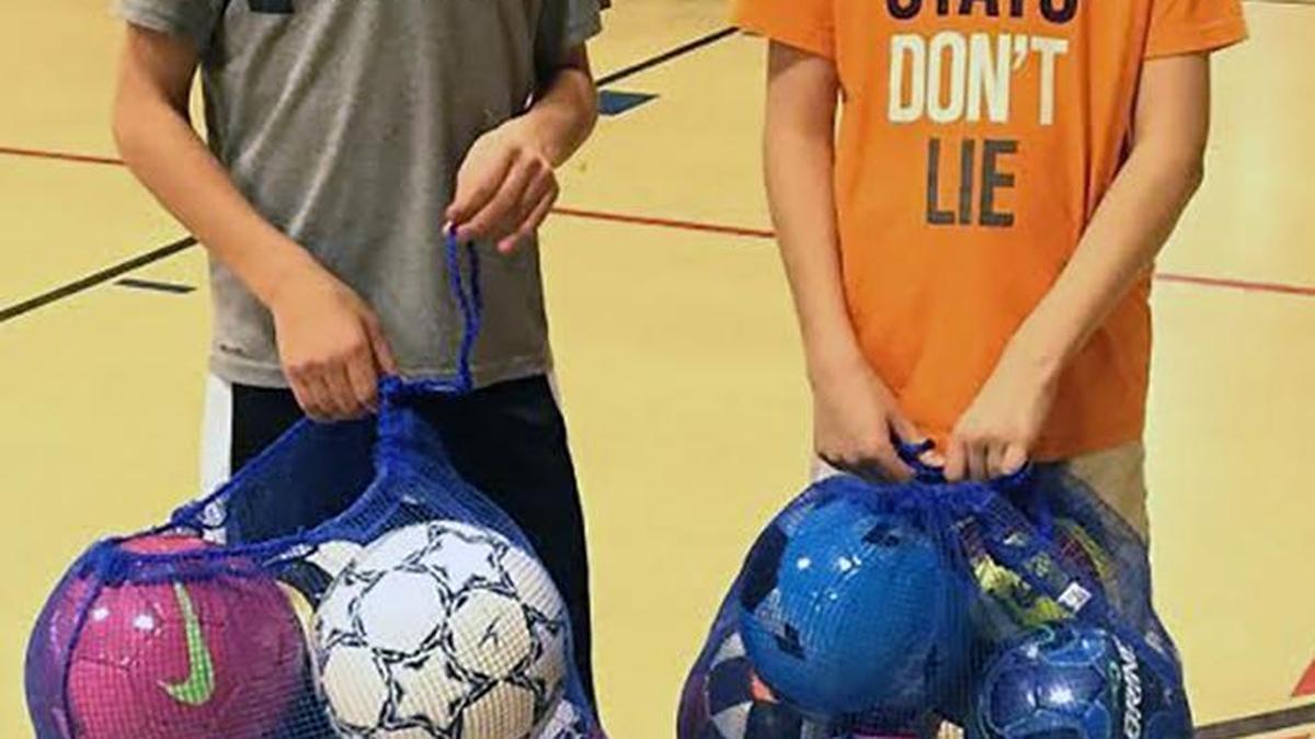 Instead of receiving gifts at their 12th birthday parties, Wyatt Erber, left, and Parker Scottberg collected soccer balls to give to Tri-City YMCA.