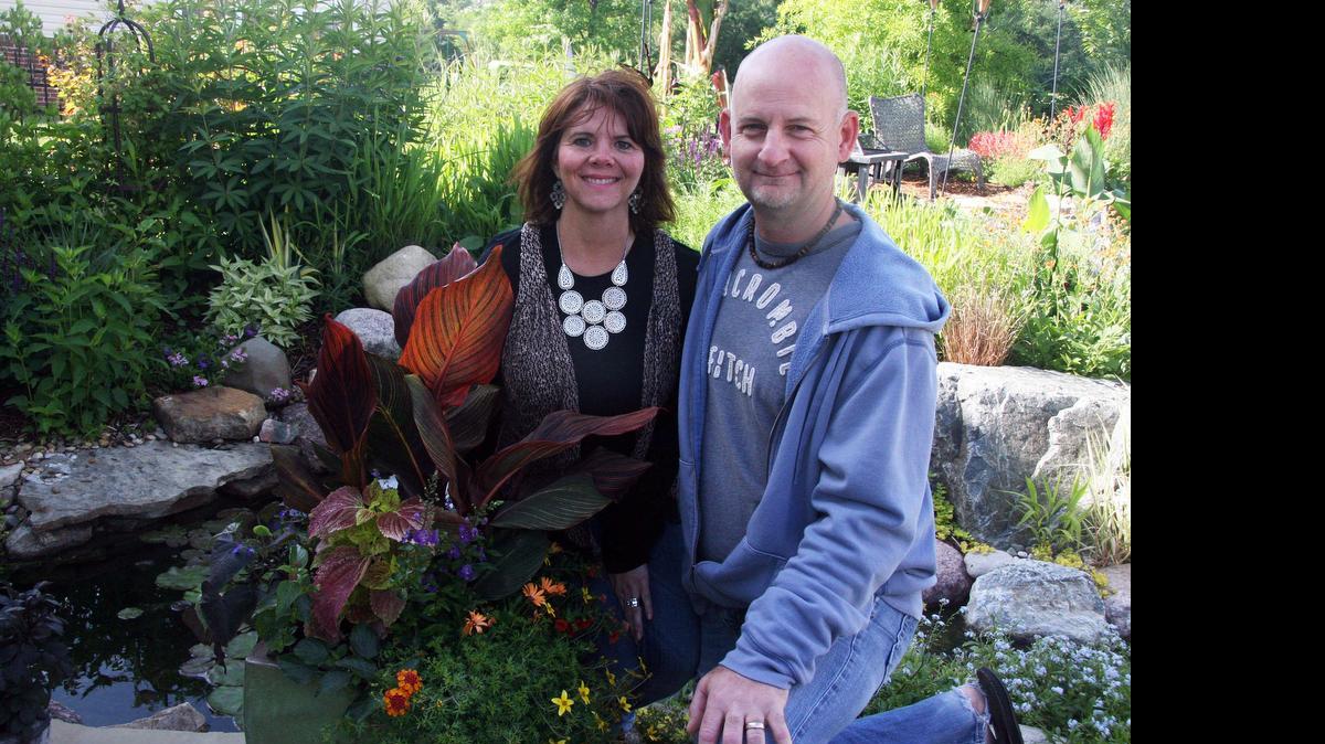 
Kevin and Kandy Behn, of Swansea, have three koi ponds in their plant-filled backyard, including a natural swimming pond. The yard, front and back is filled with flowering plants and shrubs.
