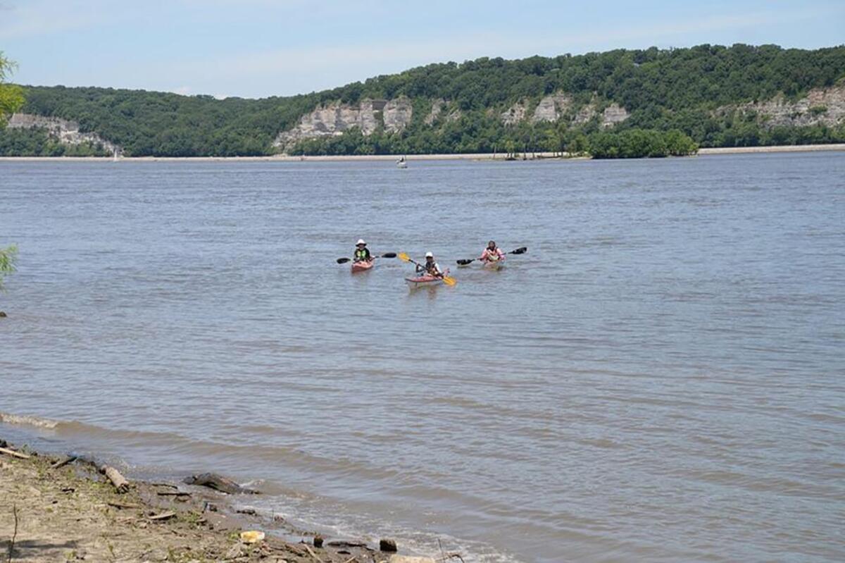 Wood, Twillman and Heddinghaus paddle toward shore at Hideaway Harbor Park in St. Charles County, Mo. after traveling more than 1,000 mile along the Mississippi River.