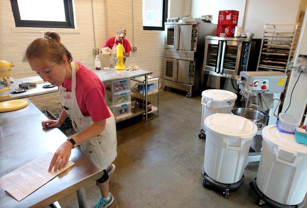 Owners Heather Wolter, left, and her sister, Danielle Muertz, work in the kitchen at Schnickelfritz Bakery in Red Bud.