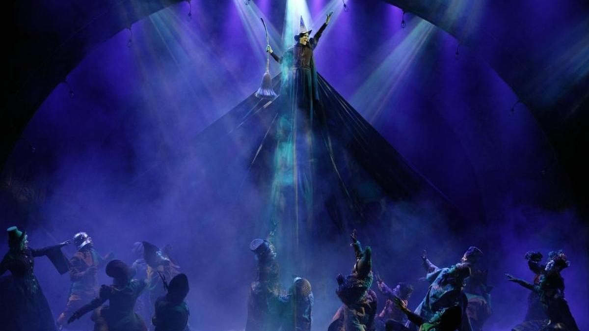 Emily Koch flies high above the stage in a scene from “Wicked.’