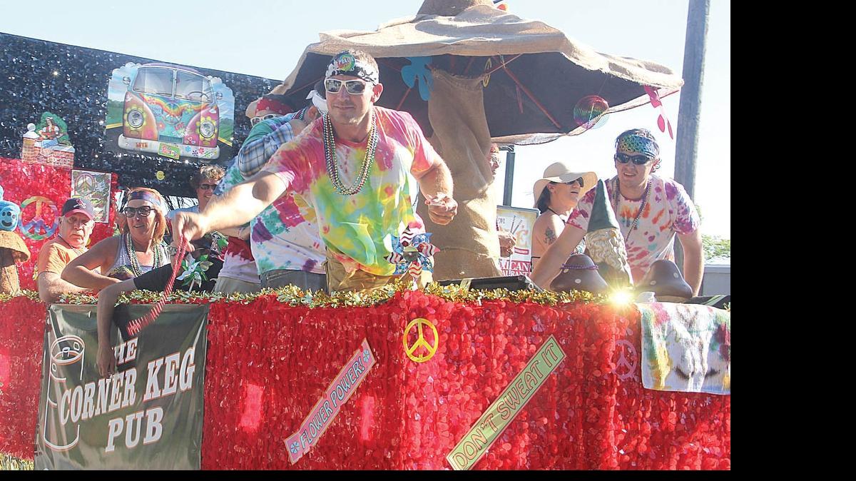 
Chris Yont throws beads from a float entered by the Corner Keg in Highland in last year's Schweizerfest parade.
