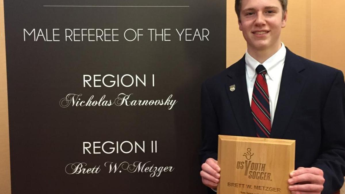 Brett Metzger, 18, of Collinsville, with his US Youth Soccer award as a referee of the year finalist. He and his parents, Dana and Bill Metzger, traveled to Baltimore in January to attend the awards ceremony.
