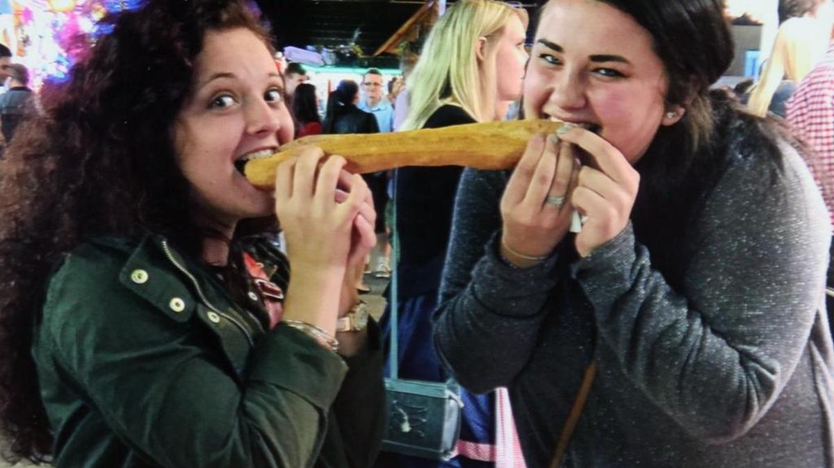 Mackenzie Vollmer, of Fairview Heights, and Alex Beatty, of Millstadt, share a bratwurst during their semester abroad in Regensburg, Germany. They attend Murray State University in Kentucky.