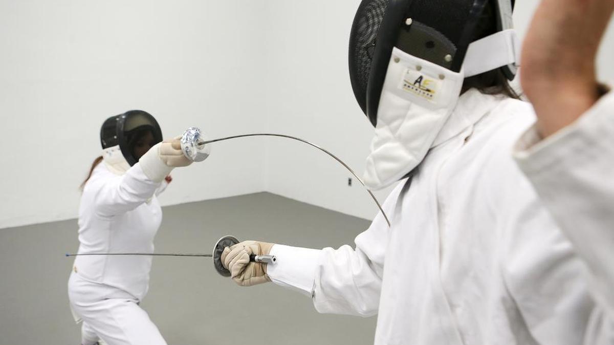 
Jessica Gatlin, left, president of the SIUE Fencing Club, spars with Nigel Knutzen, vice president, at the SIUE Student Fitness Center. Their foils have plastic buttons on the ends of flexible blades for safety purposes.

