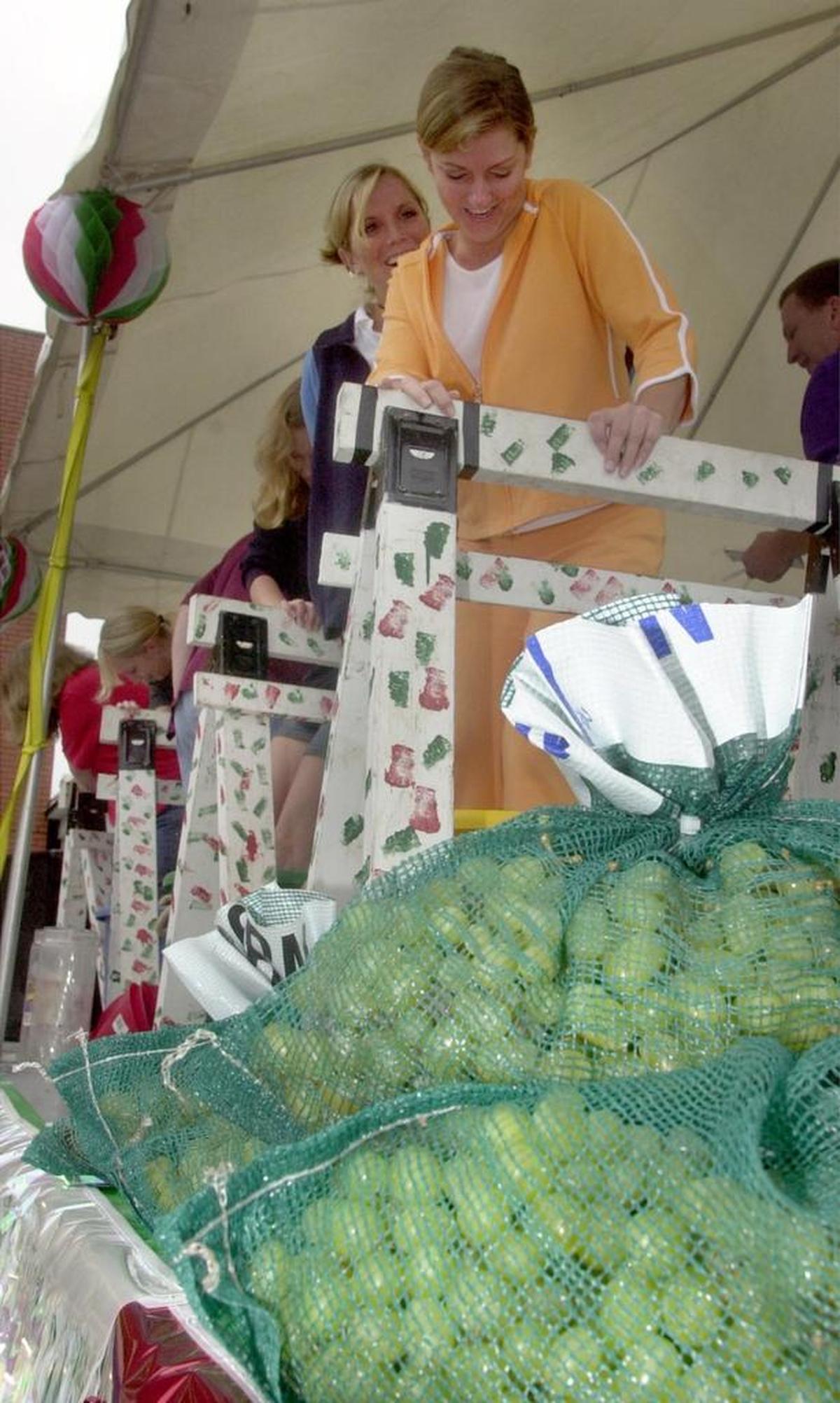 Left to right: Staci Brown and Heather Krause stomp grapes during the annual Italian Festival in Collinsville.