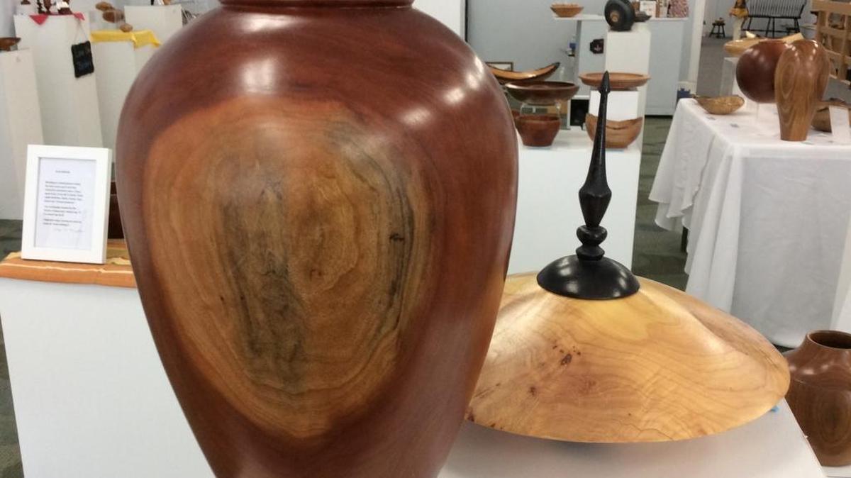 A one-of-a-kind cherry vase and a burr maple bowl with spindle top are among many turned wood pieces sold at Turned Treasures Gallery in downtown Belleville.
