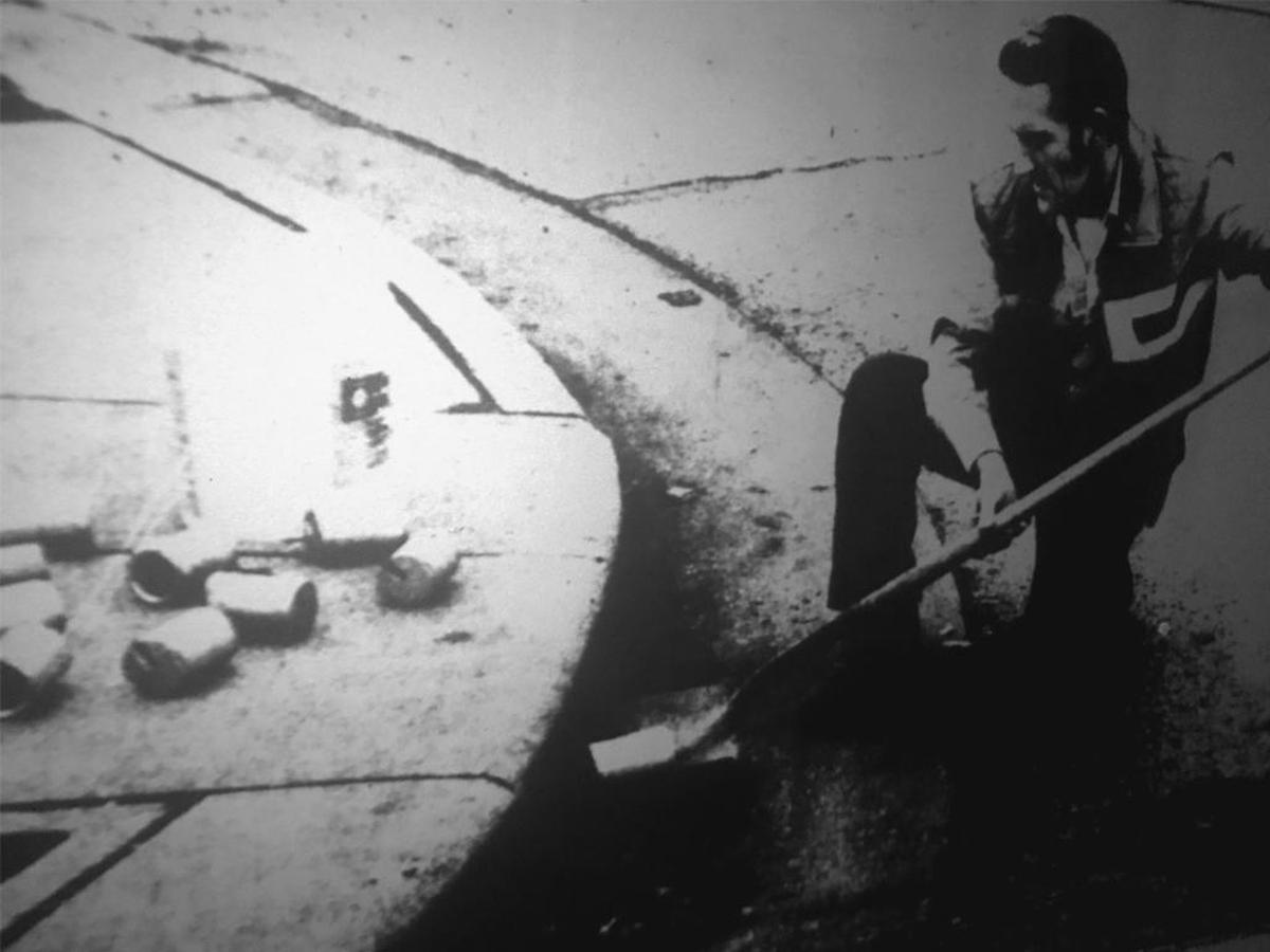 Don Arnold, the superintendent of sewer lines, removes coin canisters from the sewers at South Charles and East Lincoln Streets.