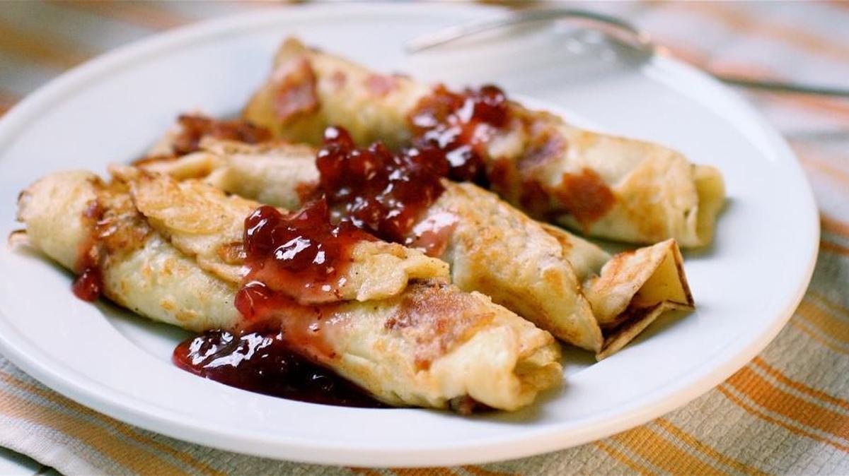 Swedish pancakes are thin, eggy and traditionally served rolled up with powdered sugar and lingonberry preserves.