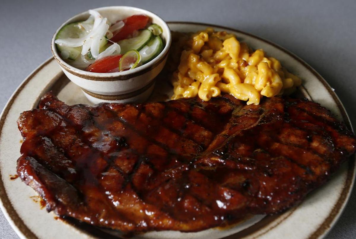 A chocolate barbecue pork steak, mac and cheese and a cucumber, tomato and onion salad at The LakeHouse at Buffalo Park in Maryville ($6.98).