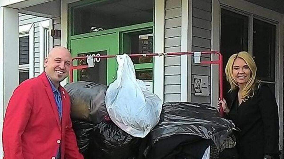 Navy veteran Joshua Hughes, of Staunton, a member of the St. Louis Red Coats, delivers a donation of gently used clothing for families in need to Cindy Drum, executive director of Contact Ministries in Springfield, Ill. The Red Coats is a veterans group with members who also are fans of the St. Louis Cardinals.
