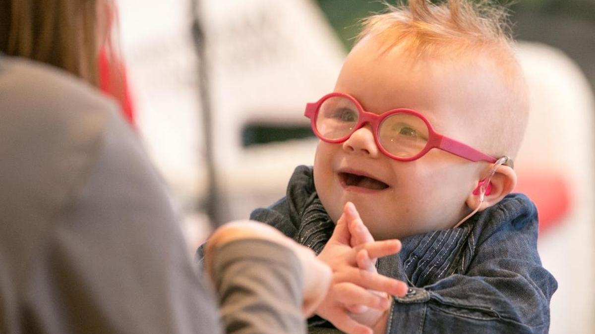 Fallon Schlautman, 19 months, is all smiles as she claps her hands during a developmental therapy session with Kim Stamps at Fallon’s Beckemeyer home.
