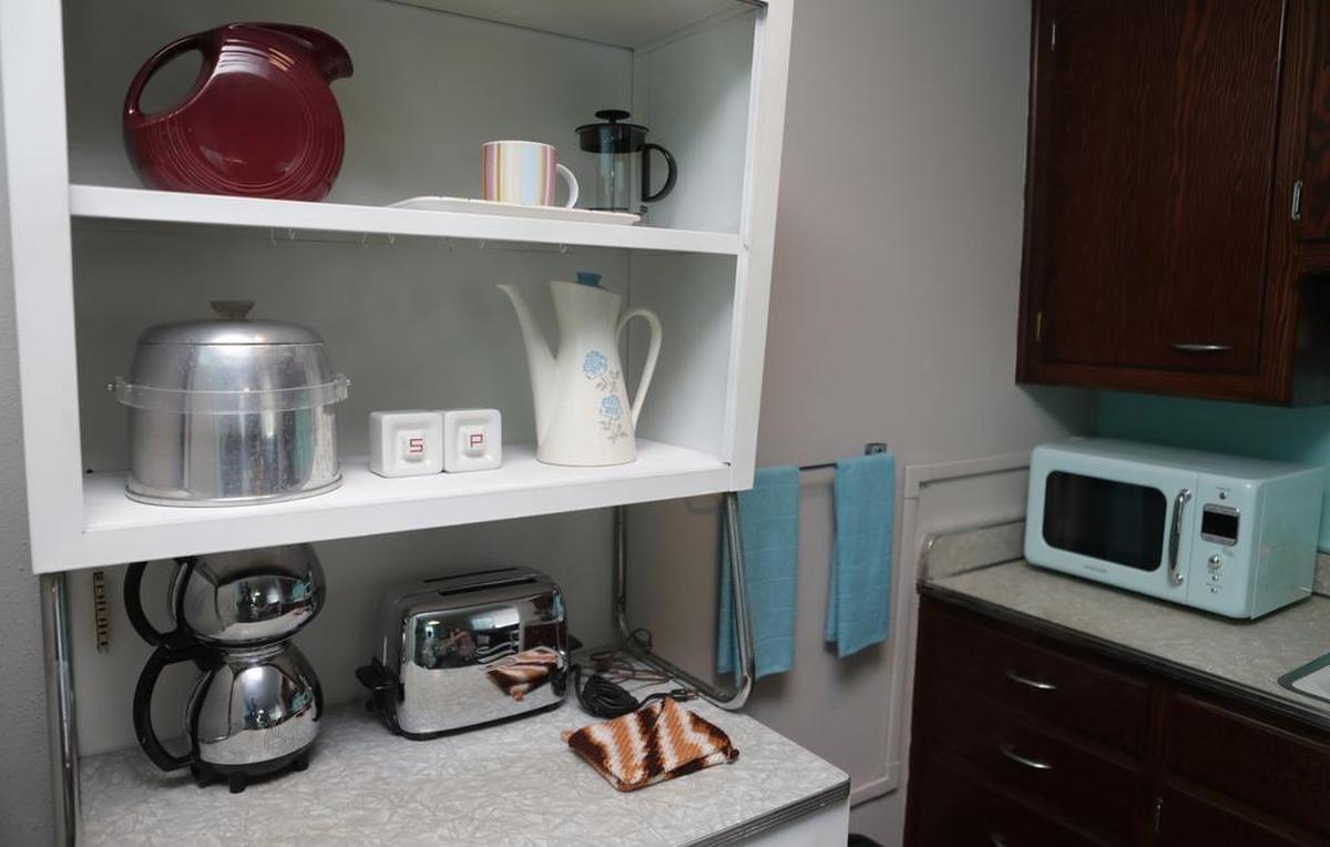 The kitchenette in Aunt Vi’s Apartment in Belleville is equipped with a retro microwave, vintage toaster and other items from the ’50s.