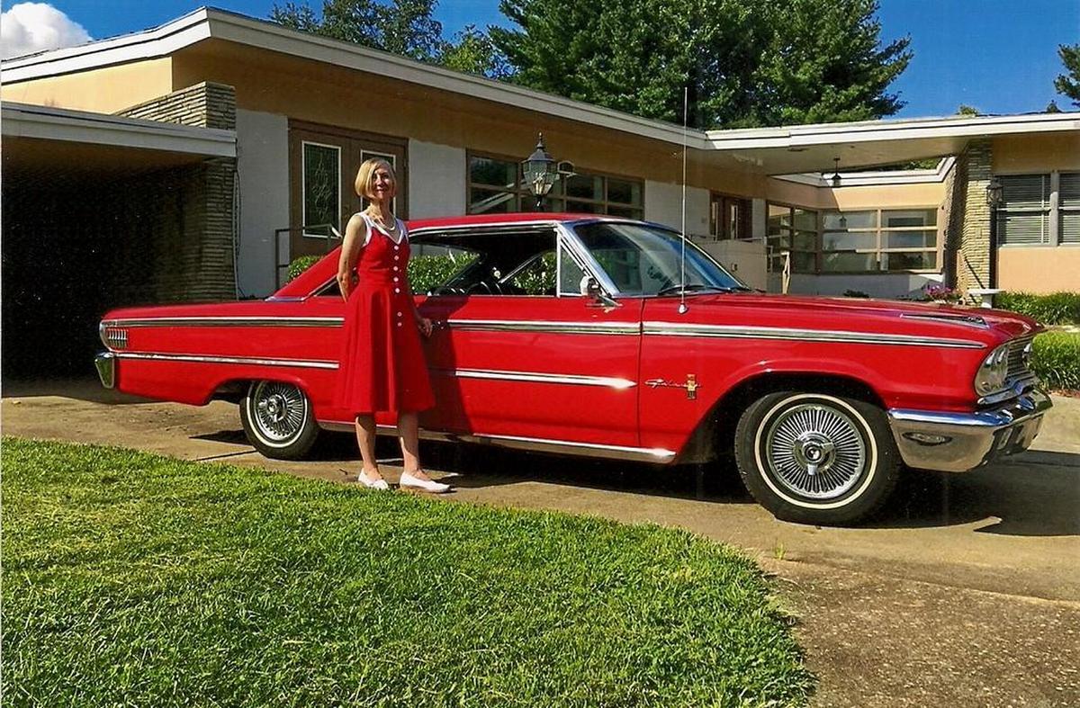 Margaret Meyers poses in a vintage dress next to a 1963 1/2 Ford Galaxy 500X owned by Belleville Historical Society president Larry Betz outside the future home of the Midcentury Modern Architecture Museum in Belleville.