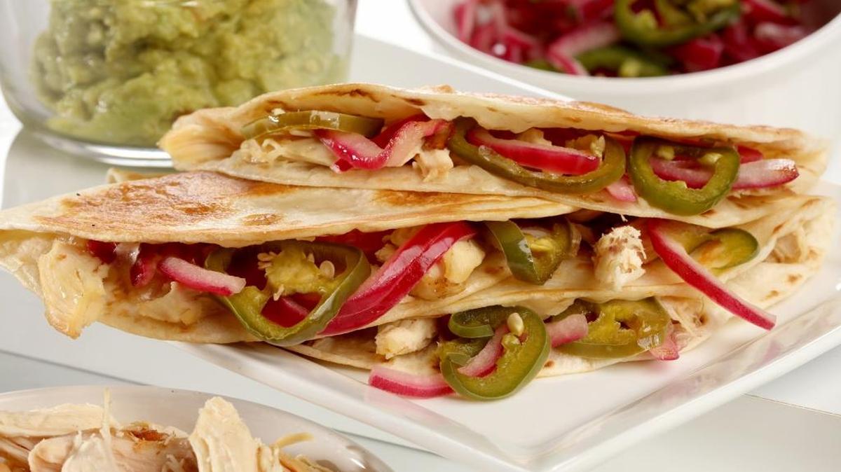What do you want to stuff in your quesadilla? These chicken quesadillas are brightened with red onion and jalapenos, plus melted cheese.