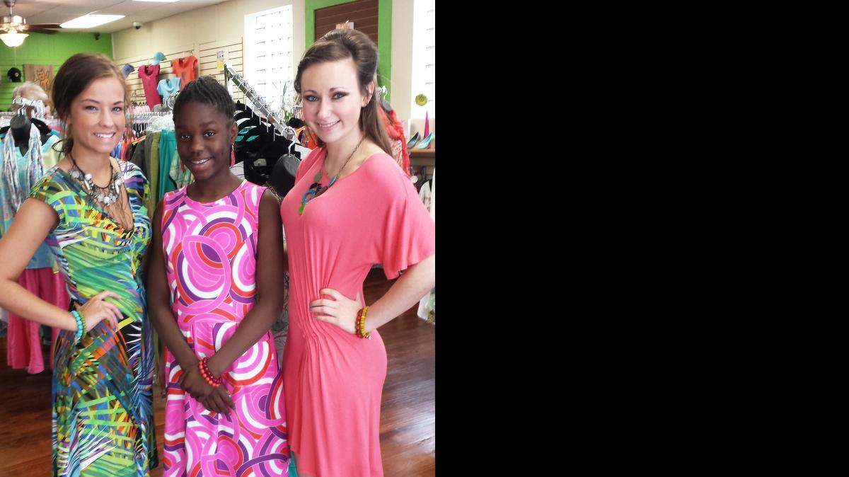 
From left, Megan Beyer, 18, Jalicia Whitfield, 13, and Emily Mulligan, 21, strike a pose inside Peace by Piece in downtown Belleville. They will be among 20 models to hit the runway Thursday  during a fashion show in Edwardsville to benefit the Christian Activity Center in East St. Louis.
