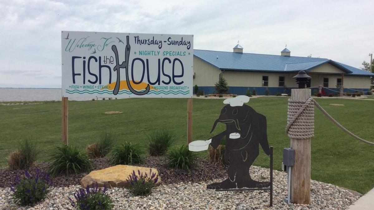 The FishHouse Restaurant sits on a rise of green lawn with a view of Lake Carlyle.