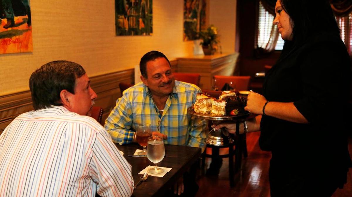 
Server Jessica Sprague shows Jeffrey Pyle and Tim Altadonna the dessert tray at Frankie's on the Hill in Nashville.
