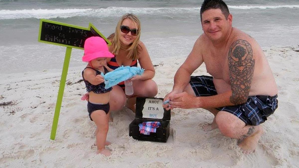 
John and Heather Herzig, of Hoyleton, with daughter Charlotte. They revealed the gender of their second child on a beach in Florida.
