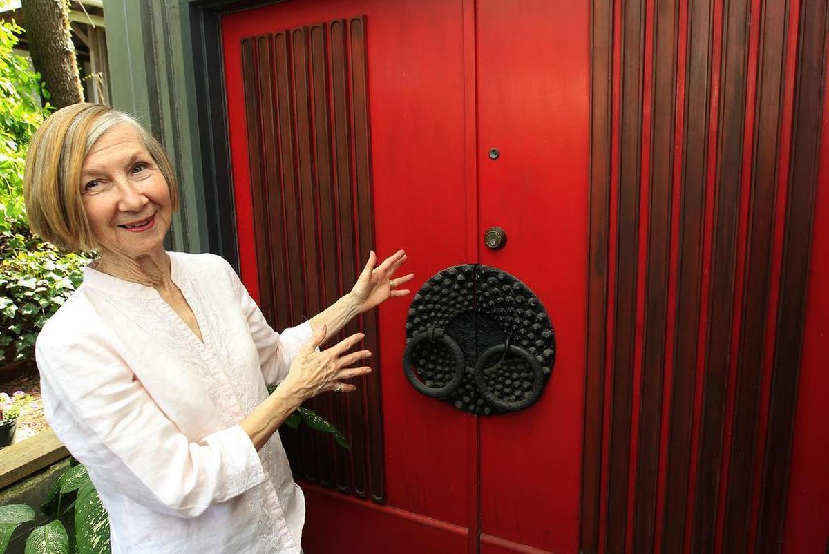 Margaret Meyer shows off the eye-catching red double door on her Signal Hill home, which was designed by Belleville architect Charles King in the early 1950s.