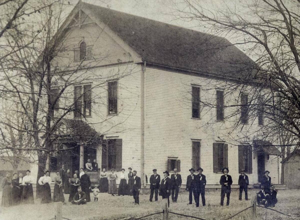 Turkey Hill Grange members in their Sunday best pose outside a frame hall that served as their headquarters before a brick hall was built in 1937.