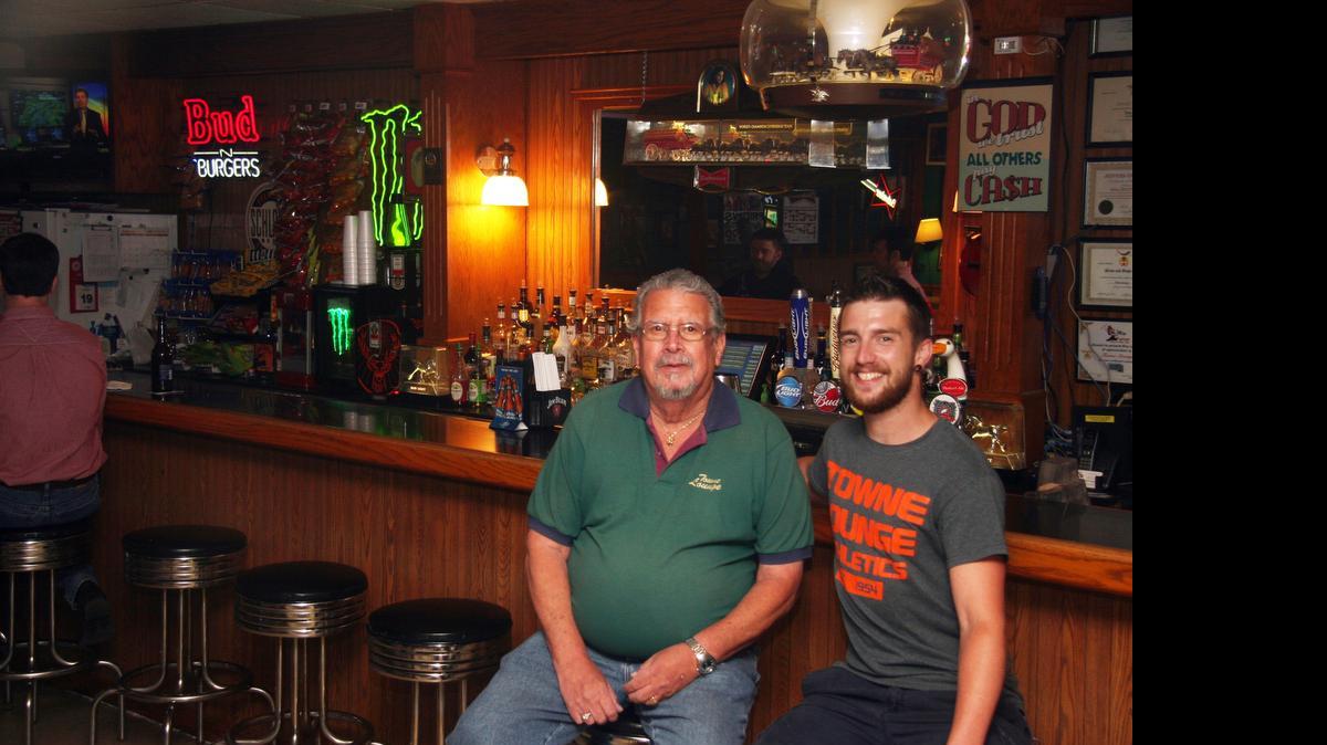 
Terry Wray and son T.J. at Towne Lounge in O'Fallon. Terry considered selling the bar before getting his son involved. 
