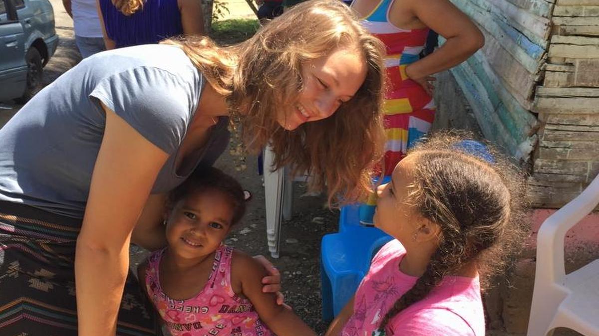 
Nursing student Emily Beyersdorfer, 22, of Belleville, gets to know children in the village of La Bestia during a Creighton University medical outreach trip to the Dominican Republic last summer.
