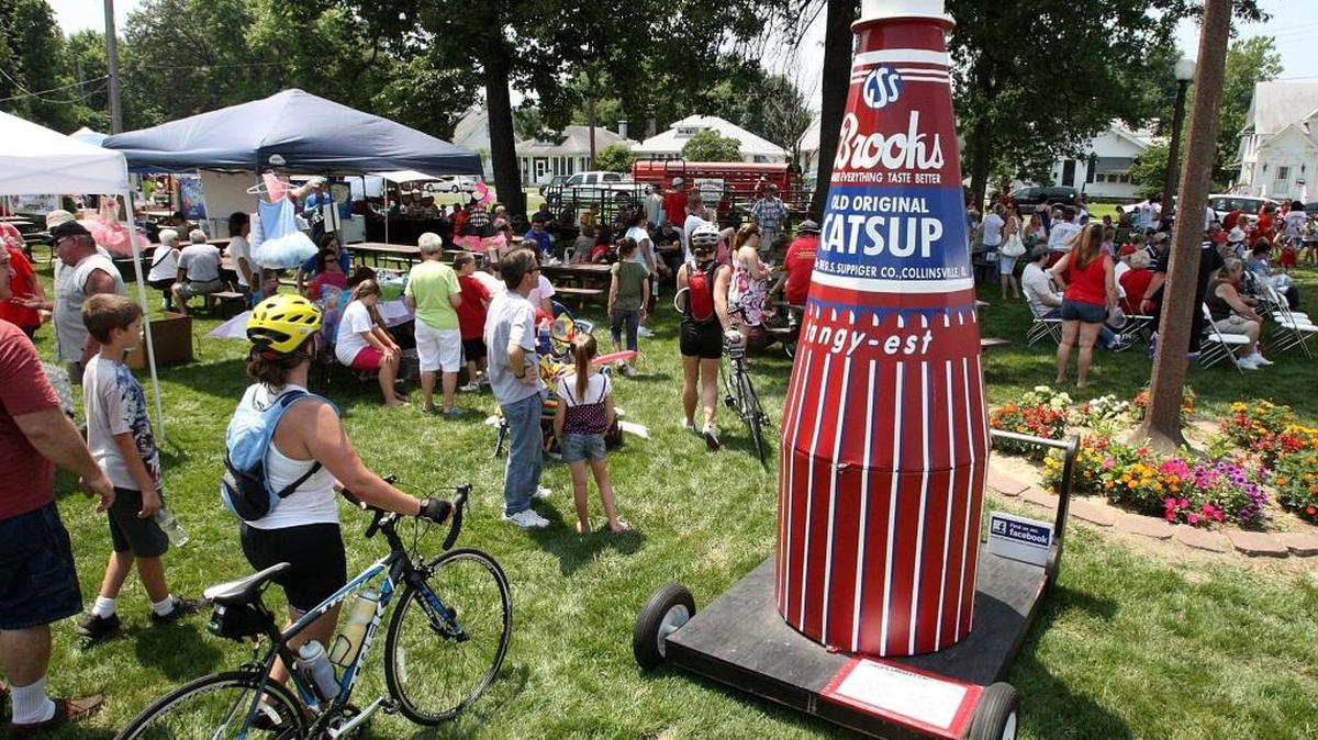 Attendees file past a model of the Brooks Catsup bottle at The World's Largest Catsup Bottle Festival in Collinsville.