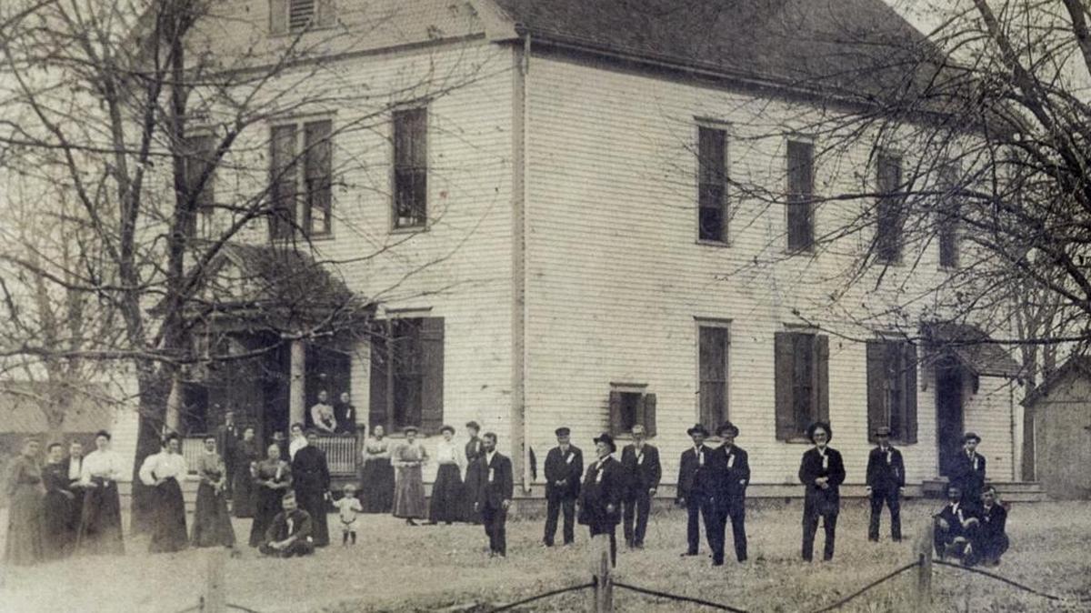 Turkey Hill Grange members in their Sunday best pose outside a frame hall that served as their headquarters before a brick hall was built in 1937.