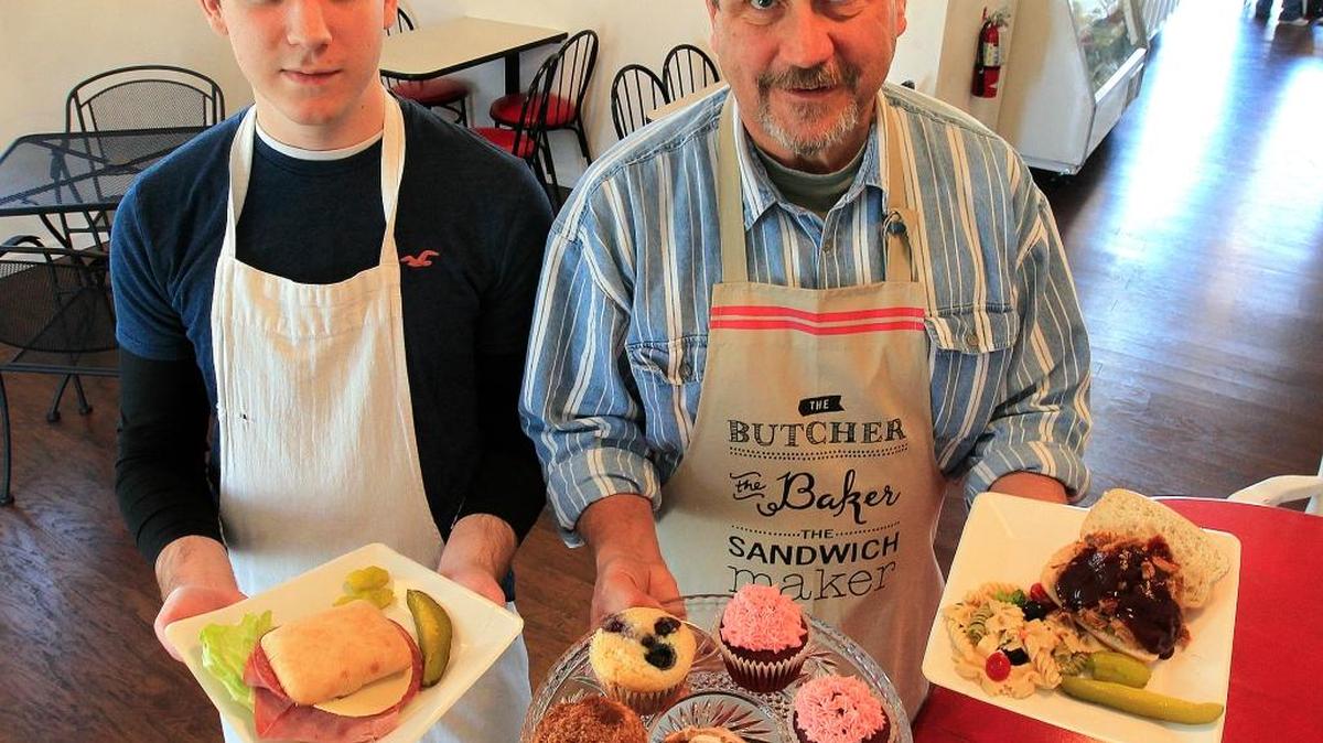 At Nanny Lou's Kitchen in Belleville, staffer Andrew Fallen, left, holds the What’A Ciabatta sandwich, and owner Mike Buettner holds a plate of freshly-baked pastries and a barbecue pulled-pork sandwich.