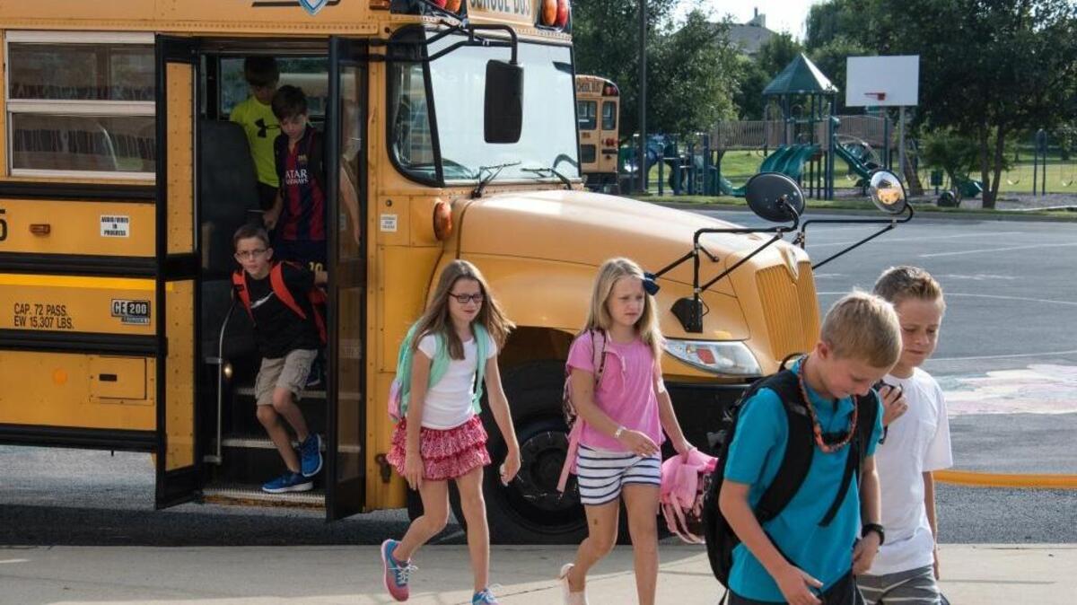 Moye Elementary School students get off the bus in an orderly fashion on the 2015 first day of school.
