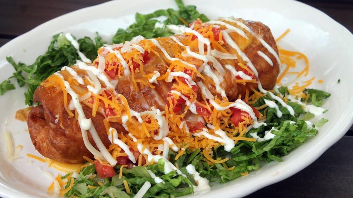 
A chimichanga, $9.95, is made with blackened chicken, green pepper, onions and assorted cheeses rolled in a flour tortilla and fried to a golden brown. It's topped with shredded cheese, sour cream and chopped tomato.
