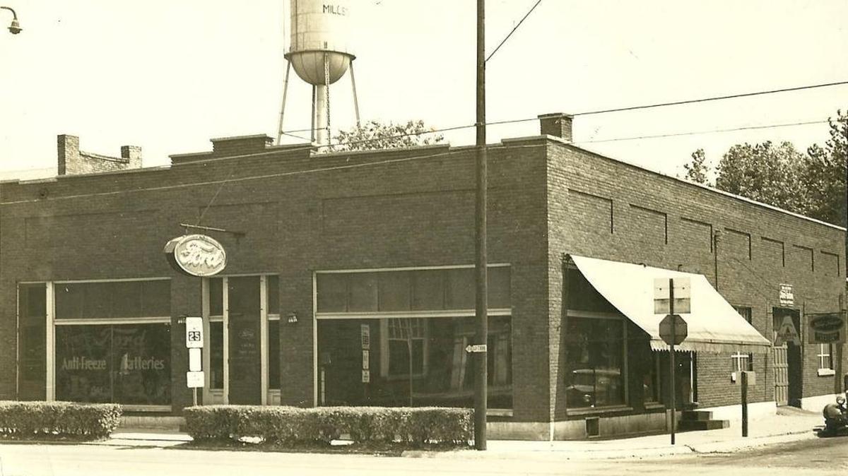 The Millstadt water tower over the Mertz Ford dealership in 1945. Some historic minded people in Millstadt were determined the village should not tear down the old Tin Man style water tower and they were willing to give their energy and money to see it saved. Against some big odds, they are succeeding and the first step in restoration, painting the outside, is under contract.