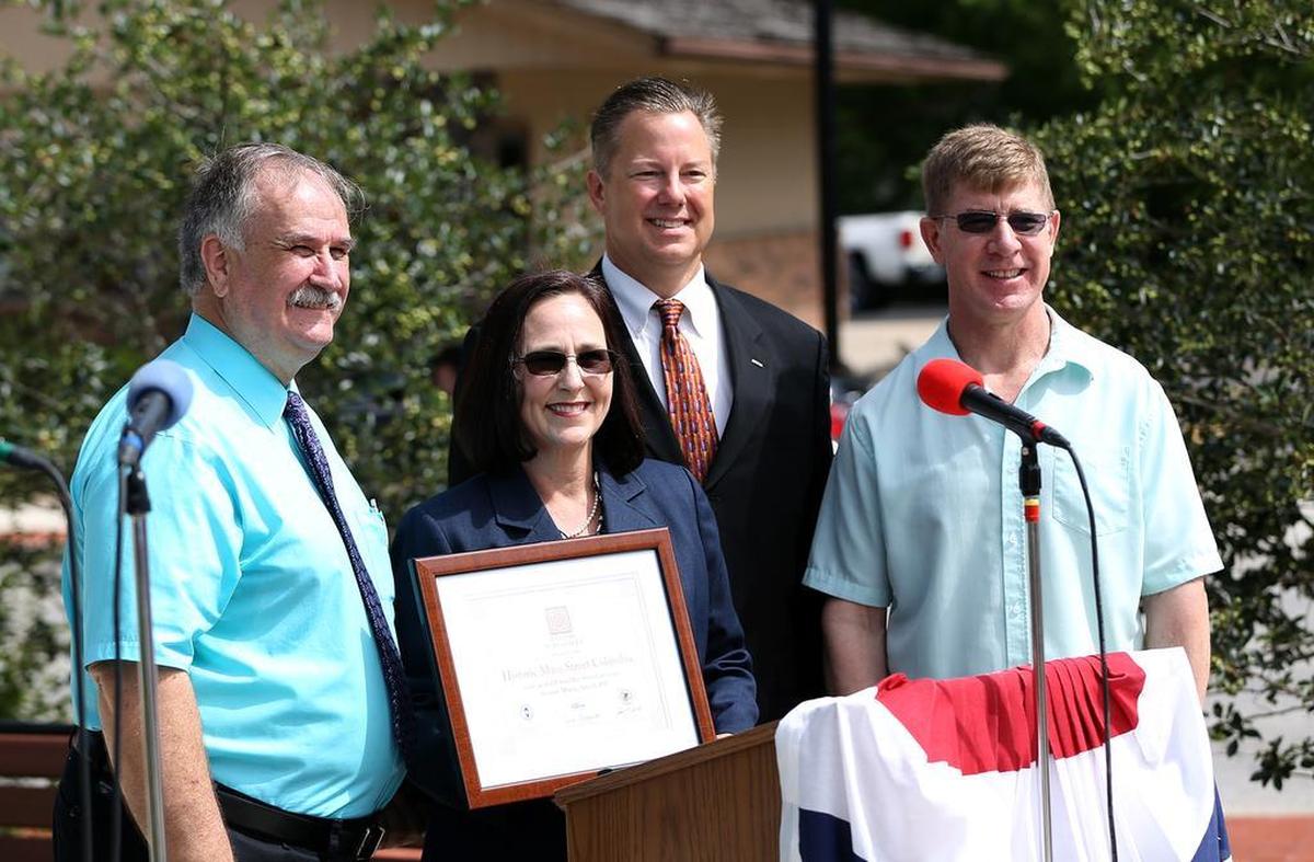 Columbia Mayor Kevin Hutchinson, second from right, poses with community leaders at a Main Street Columbia event in this file photo.